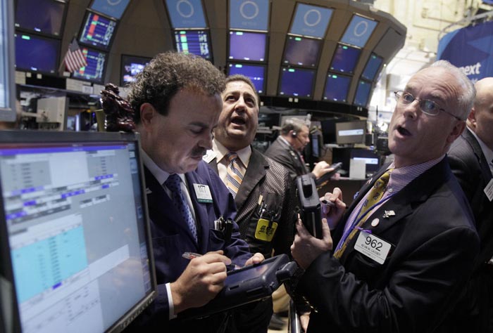 Traders react on the floor of the New York Stock Exchange today as tocks soared in morning trading after major central banks acted together to support the global financial system.