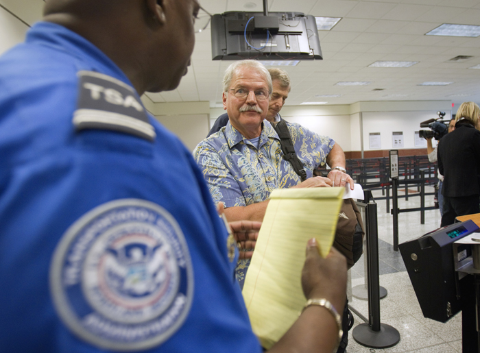 Passenger Don Heim, right, of Alpharetta, Ga., is briefed by Transportation Security Administration trainer Byron Gibson before going through a new expedited security line recently at Hartsfield-Jackson International Airport in Atlanta.