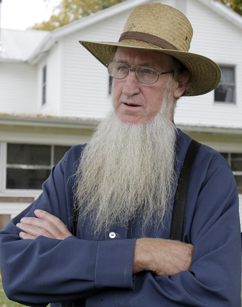 Sam Mullet stands in the front yard of his home in Bergholz, Ohio, in this Oct. 10, 2011, photo. The FBI and local sheriff's deputies arrested seven men, including Mullet, reputed leader of a breakaway Amish sect, on federal hate crime charges early today.