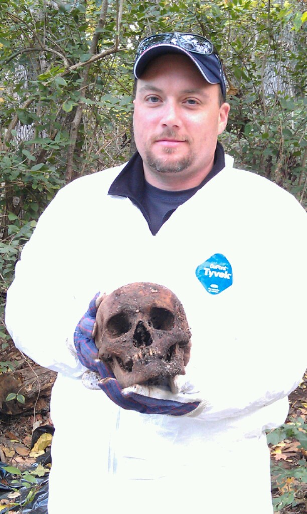 Detective Keith Cook of the Cumberland County Sheriff’s Office holds a skull recovered as part of a class on locating and exhuming human remains at the National Forensic Academy in Tennessee. At right, he’s with other crime scene investigators.
