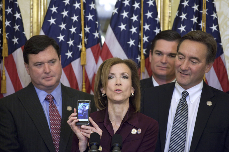 Rep. Nan Hayworth, R-N.Y., center, accompanied by, from left, Rep. Todd Rokita, R-Ind., Rep. Austin Scott, R-G., and Rep. Rick Berg, R-N.D., shows a photo of her children, Will and Jack, Thursday during a House Republican freshmen news conference on Capitol Hill to discuss a balanced budget amendment.