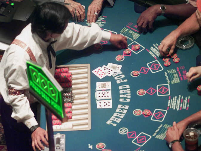 Gamblers will soon be able to place their bets on blackjack, craps and other table games in Maine. In this photo, a casino employee deals a game of poker at Station Casino in Kansas City, Mo.
