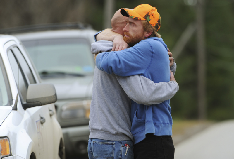 Jim Curtis, left, brother of Michael Curtis, is comforted by a friend in front of the Piscataquis Valley fairground in Dover-Foxcroft on Tuesday. Michael Curtis was shot and killed by a state trooper after walking into a nursing home and fatally shooting a maintenance worker.