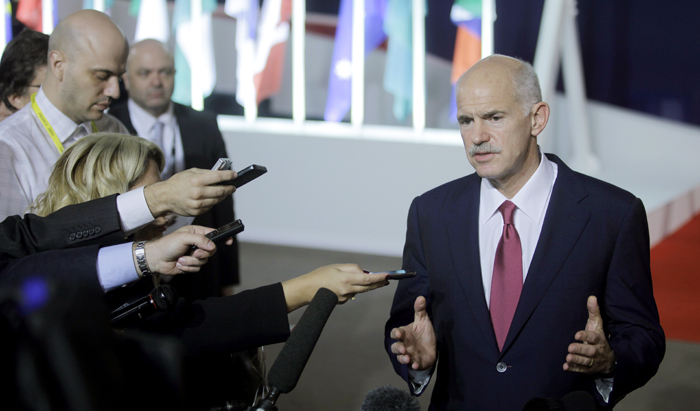 Greek Prime Minister George Papandreou speaks with the media as he leaves a G20 summit in Cannes, France, on Wednesday.