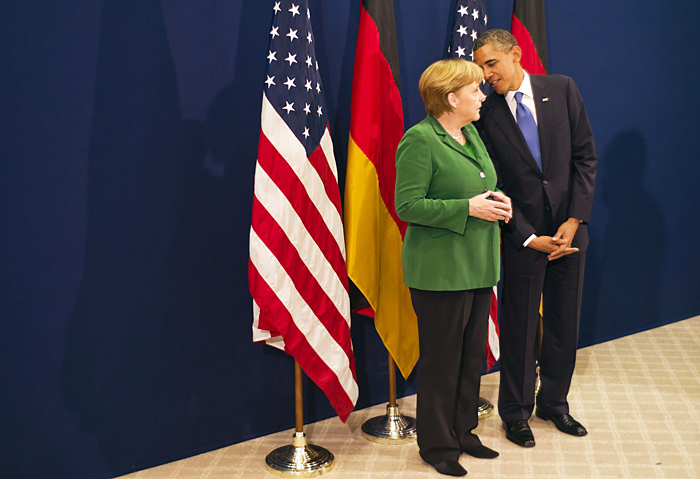In this picture released by the German government's press office, President Barack Obama talks with German chancellor Angela Merkel, prior to the start of the G20 summit in Cannes, France, today.