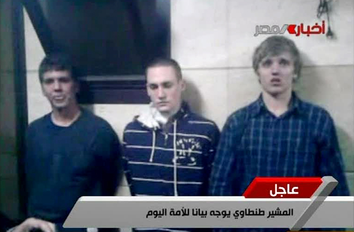 In this Tuesday image from Egyptian state television, three American students are displayed to the camera by Egyptian authorities following their arrest during protests in Cairo.