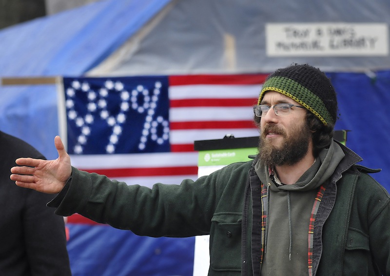 Staff Photo by Shawn Patrick Ouellette Jonah Fertig of Portland talks to a crowd at the Occupy Maine camp in Lincoln Park on Saturday, Nov. 26, 2011.