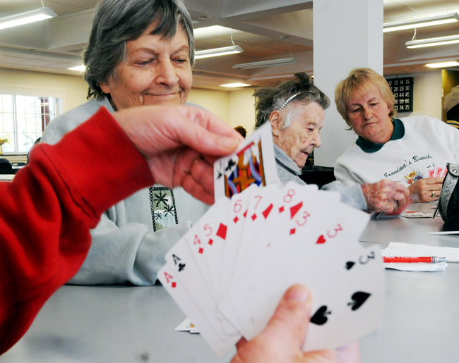 Seniors citizens pass the time playing cards on Tuesday at a shelter in Windsor Conn. Connecticut Gov. Dannel P. Malloy toured telling the 300 people using the center everything possible is being done to restore power.