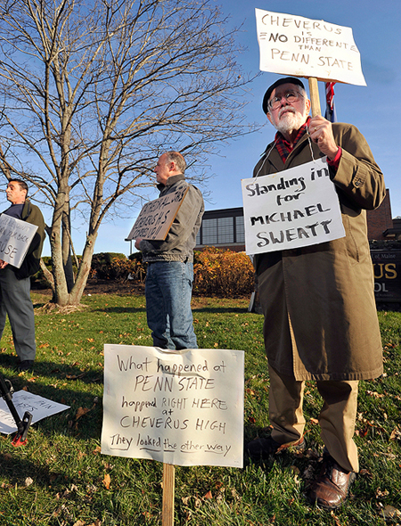 Bill Slavick, right, joins the protest in front of Cheverus High School, as does Rick Romano, middle, who said he was abused in Cathedral School by a teacher who was later hired at Cheverus, according to Romano. John Clark, left, said he was abused as well, according to Clark.