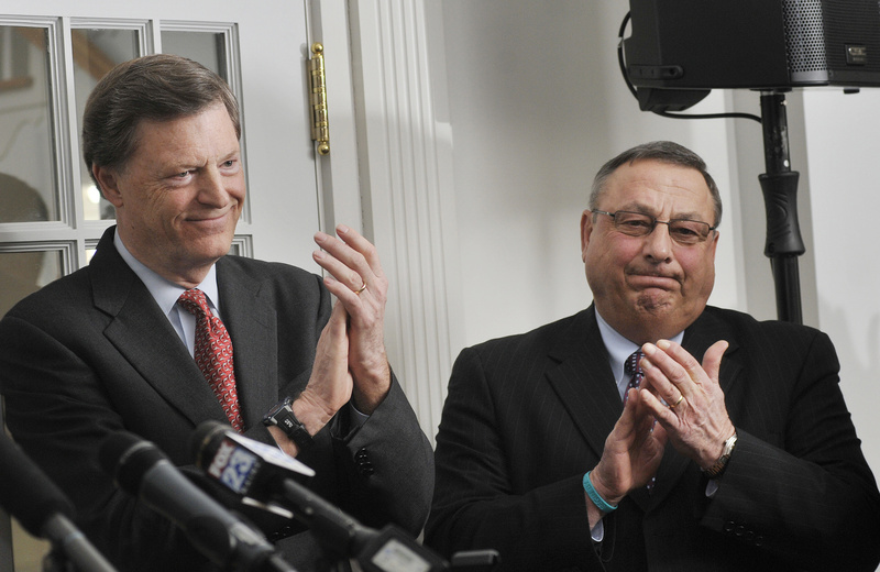 Former Gov. John McKernan, left, and Gov. Paul LePage applaud the fundraising effort in support of Maine's community colleges at Southern Maine Community College in South Portland on Monday.