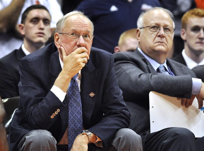 In this Nov. 14, 2011, photo, Syracuse basketball coach Jim Boeheim, left, watches the action with Bernie Fine, his assistant coach, during a game against Manhattan in the NIT Season Tip-Off in Syracuse, N.Y.