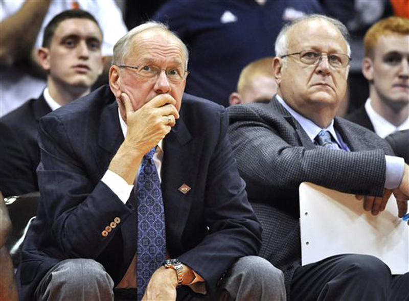 In this Monday, Nov. 14, 2011, photo, Syracuse basketball coach Jim Boeheim, left, watches the action with Bernie Fine, an assistant coach, during a college basketball game against Manhattan in the NIT Season Tip-Off in Syracuse, N.Y. ESPN reported Thursday, Nov. 17, that police were investigating Fine on allegations of child molestation. Shortly afterward, Syracuse placed Fine on administrative leave "in light of the new allegations and the Syracuse City Police investigation," the school said. (AP Photo/Kevin Rivoli, File)