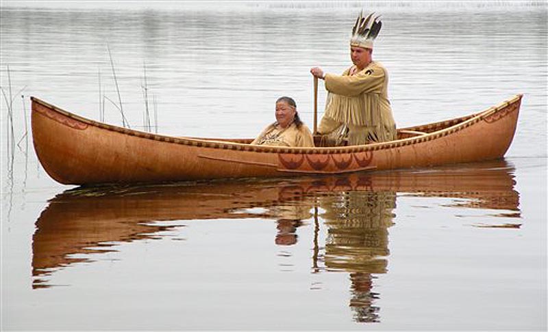 This October 2011 photo provided by the Passamaquoddy tribe shows Chief Joseph Socobasin paddling a birch canoe with his grandmother Joan Dana in Indian Township, Maine. Though Maine voters rejected a racetrack casino on Nov. 8, 2011, that would have helped bolster the tribe's economy, they are looking to wind, water and land for other means of economic development. (AP Photo/Martin Dana)
