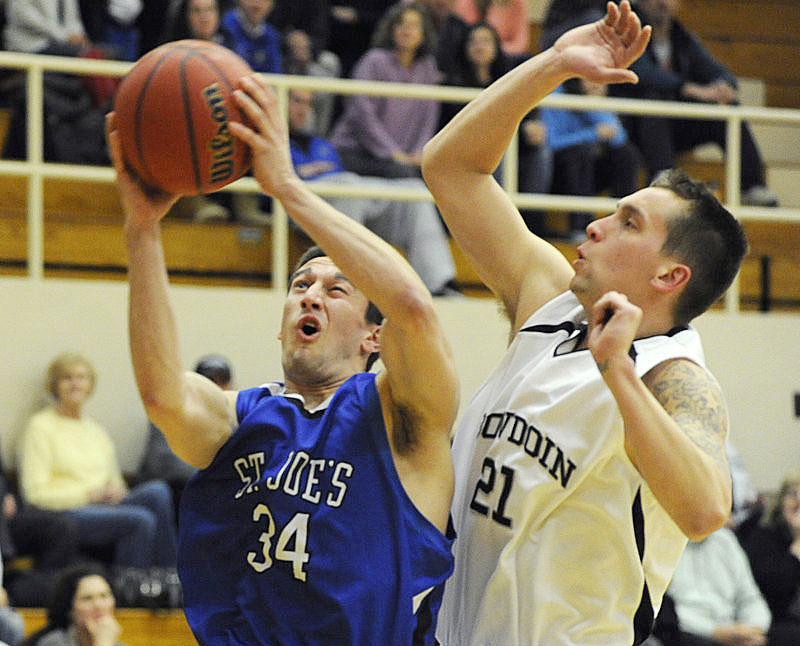 Chris Petzy, who hit seven 3-pointers for St. Joseph s, goes inside against Ryan O Connell of Bowdoin in a 70-68 victory Tuesday night.