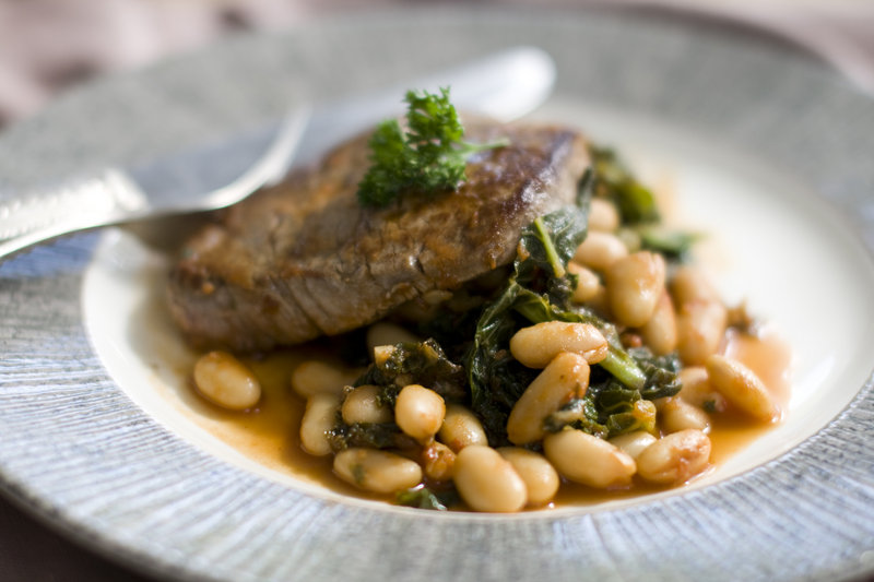 Filet of beef a la romana pairs lean tenderloin with healthy kale and cannellini beans in a flavorful combination.