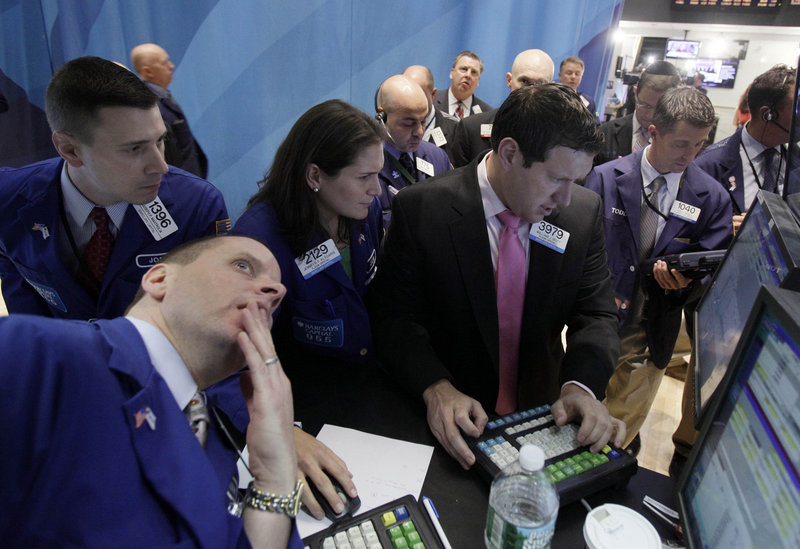 Specialists Jennifer Klesaris and William Bott, right center, work at a post on the floor of the New York Stock Exchange on Tuesday. Concern over the potential collapse of a bailout for Greece roiled the markets.