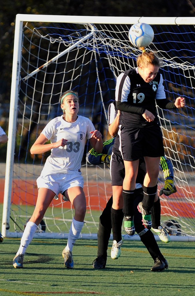 Dayle Jordan, who eventually scored the winning goal for St. Dominic, clears away a pass intended for Sadie Cole of Waynflete in the second half.
