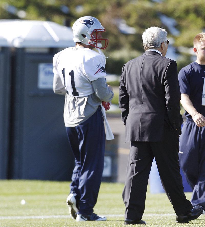 Julian Edelman chats with owner Robert Kraft at practice Wednesday. The Pats had little to say about Edelman, who was arrested Tuesday morning and charged with indecent assault and battery. He did practice with the team.