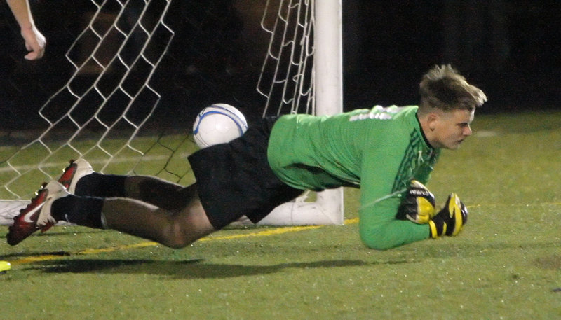 Pat Stanton of Scarborough dives for the ball Wednesday night in an effort to stop Bryan Soucy’s goal that gave Windham the Western Class A boys’ soccer title with a 1-0 victory.