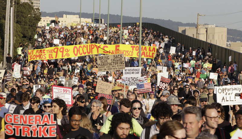 Thousands of Occupy Wall Street demonstrators march from downtown Oakland, Calif., to the port of Oakland on Wednesday, hoping to disrupt the flow of goods at the nation’s fifth-busiest port.