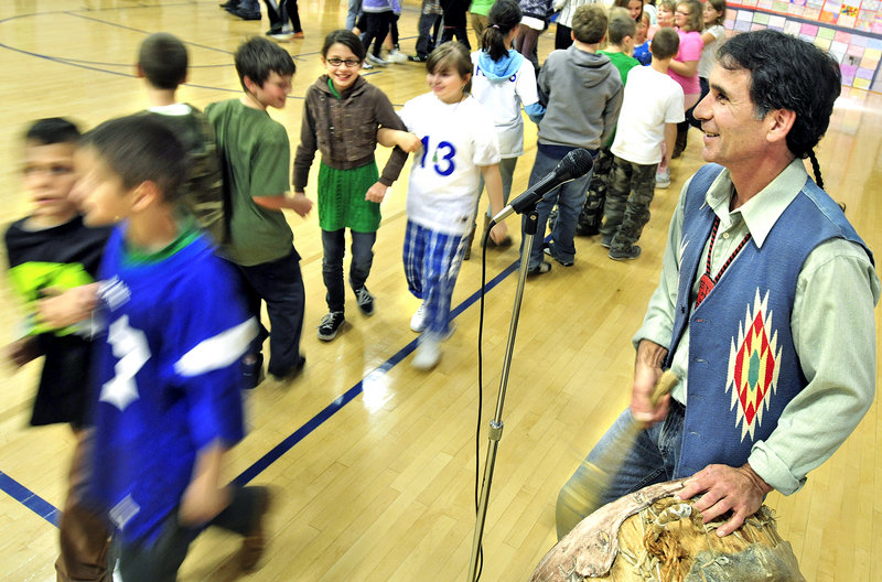 Barry Dana, a former chief of the Penobscot Nation, leads students in the alligator dance during an assembly at Sea Road School in Kennebunk on Friday. Dana spent a week teaching about traditional practices as an artist in residence at the school.