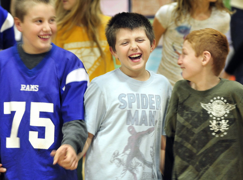 Bruno Belo, middle, and fellow Sea Road School fifth-graders Zach Johnson, left, and Colby Roy, right, perform the round dance, an American Indian tribal dance, at an assembly Friday.