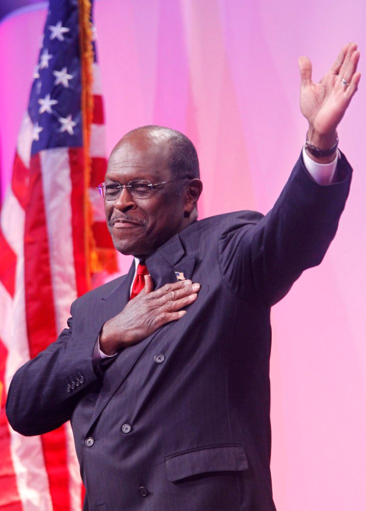 Republican presidential candidate Herman Cain gestures as he walks toward the podium before speaking Friday in Washington.