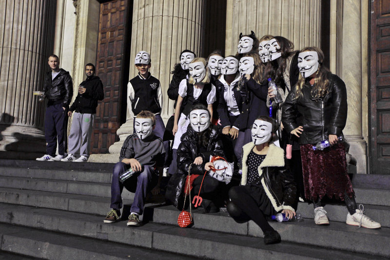 A group of London friends sport Guy Fawkes masks outside the Occupy London Stock Exchange protest camp near St. Paul’s Cathedral on Thursday.