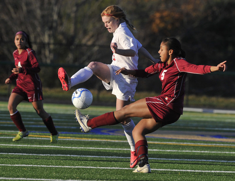 Denae Johnson, right, of Bangor and Andrea Tolman of Scarborough compete for the ball Saturday during Bangor s 4-0 win in the Class A girls' soccer state final at Falmouth.