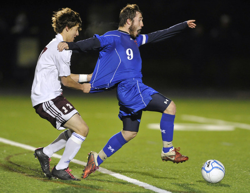 Erik Gumaer of Windham wasn't about to let Christopher Hall of Messalonskee break away Saturday night – by any means possible. Gumaer received a yellow card but helped Windham earn the Gold Ball with a 3-1 victory.