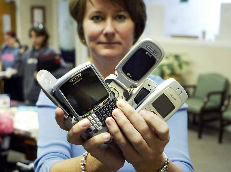 An official holds confiscated cellphones at Arlington (Texas) High School in a 2007 file photo. Because of text-message bullying, the school confiscates any cellphones that students are caught with at school and requires students to pay a fine to get them back. A national survey being released today notes that sexual harassment and bullying can sometimes overlap.
