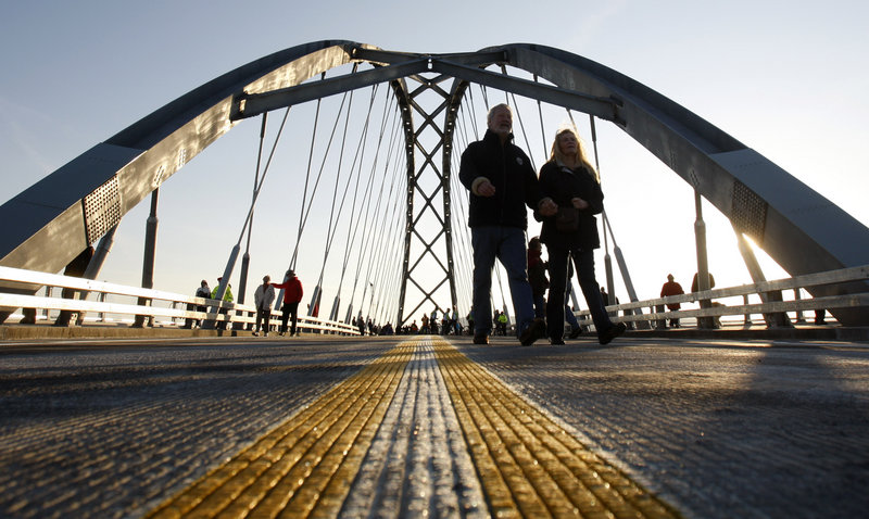 Pedestrians cross the Lake Champlain Bridge after a dedication ceremony Monday in Crown Point, N.Y. The original span was closed in 2009 after it was deemed unsafe. The bridge reconnects Crown Point and West Addison, Vt.