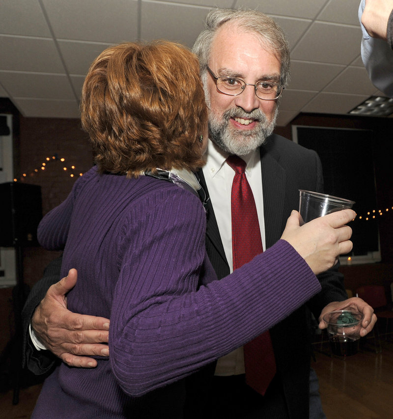 Victorious mayoral candidate Alan Casavant gets a hug at his election night reception at the North Dam Mill. He told supporters: “We need to accentuate Biddeford’s attributes as a great place to live and work and go to school.”