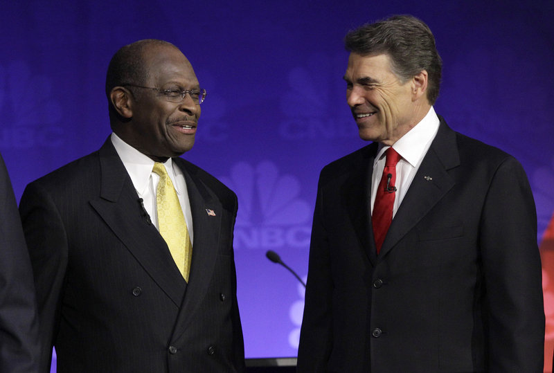 Republican presidential candidates businessman Herman Cain and Texas Gov. Rick Perry talk before the Republican presidential debate at Oakland University in Auburn Hills, Wednesday. The debate focused mostly on the economy with all the candidates sounding a similar refrain against direct U.S. aid in the European debt crisis.