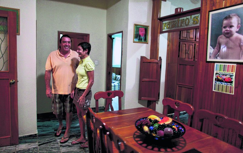 Tania Duran and her husband Fernando Ramiro stand Thursday in their home in Havana they have just put on the market A new housing law allowing Cubans to freely buy and sell their homes took effect Thursday.