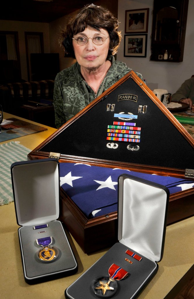 Nancy Lee Kelley, who will serve as grand marshal in today s Veterans Day Parade in Portland, lost her son, Army Capt. Christopher Cash, when he was killed by insurgents in Iraq in 2006. The Old Orchard Beach Gold Star Mother displays her son s medals and the flag that draped his coffin at his funeral.
