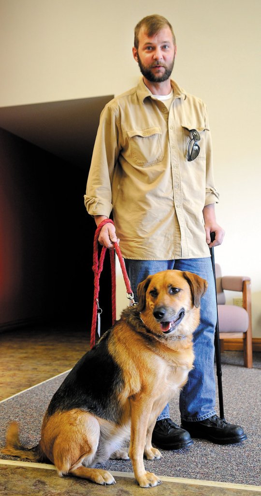 Former Army Sgt. Aaron Rollins and his service dog, Mabel, are shown recently in Augusta.