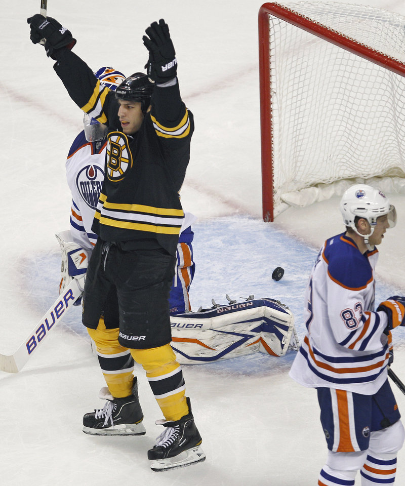 Milan Lucic celebrates after a shot by Bruins defenseman Johnny Boychuk eluded Edmonton goalie Devan Dubnyk for a first-period goal Thursday. Lucic scored in the third period to help Boston secure a 6-3 win.