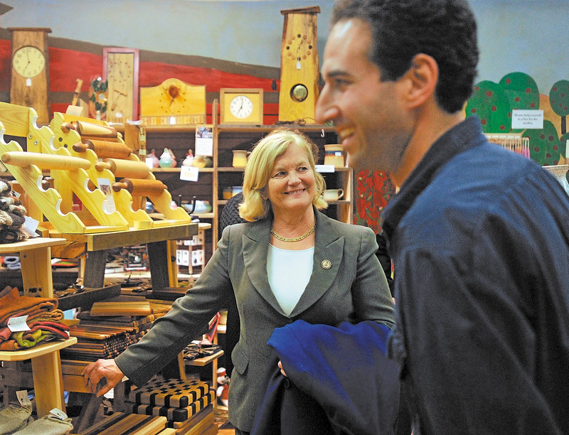 U.S. Rep. Chellie Pingree, center, talks with David Gulak, a store manager in Waterville, during a visit to the city Thursday. If Pingree wins re-election, Waterville will be in the 1st District because of redistricting.