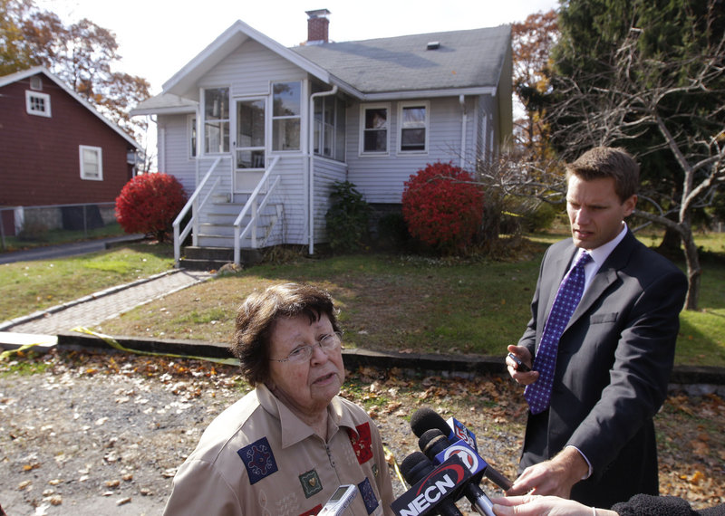 Pat Connor, a neighbor, talks to reporters in front the house in Weymouth, Mass., where police say three people were killed Friday. Donald Rudolph, 18, has been charged in the killings of his mother, older sister and his mother’s boyfriend after police found a “gruesome scene” at the home.