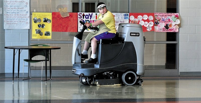 Mario Montana of Troy operates a floor cleaning machine at Mount View High School in Thorndike recently.