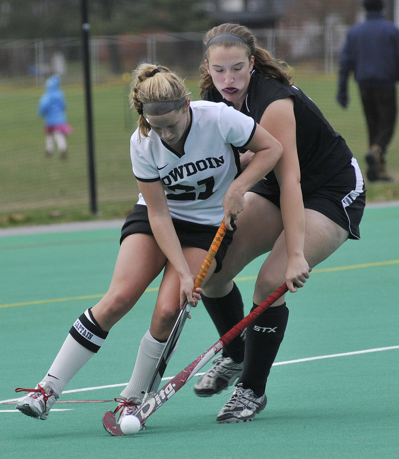 Katie Herter of Bowdoin battles for the ball Sunday in the third round of the NCAA Division III field hockey tournament against MIT. Bowdoin won, 3-0.