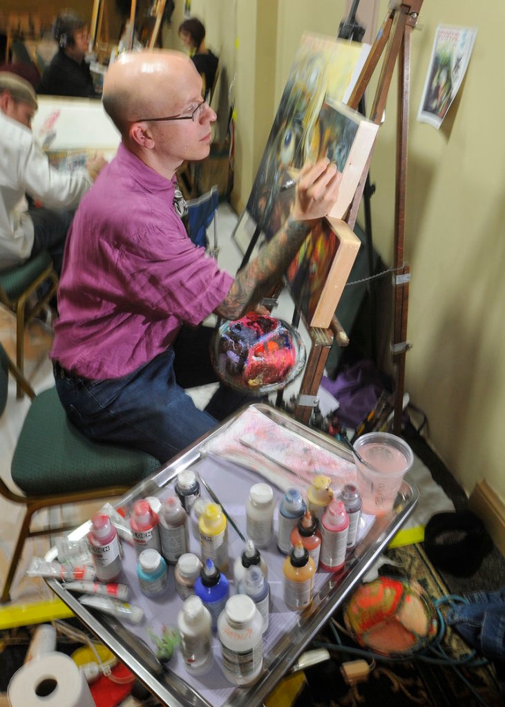 Chris Dingwell, a Portland tattoo artist, paints in front of an audience along with other local artists at the comics and fantasy entertainment convention Sunday.