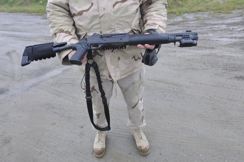 Lt. Gary Hutcheson, a Portland police firearms instructor, shows a Benelli M4 12-gauge shotgun during training. The weapon is safer than others for police in an urban setting.