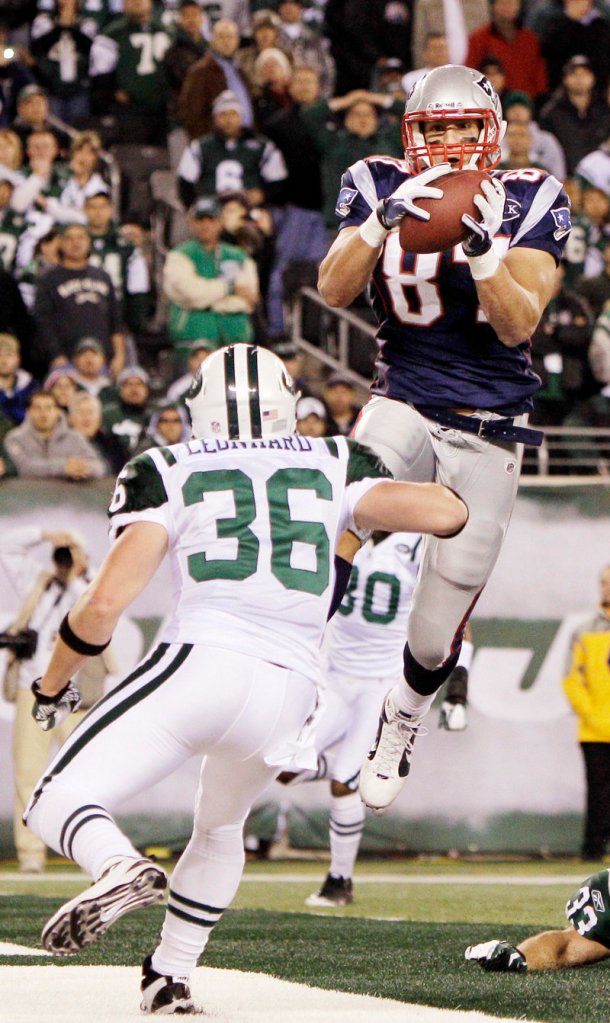 Rob Gronkowski catches a TD pass in the second quarter Sunday night in front of Jim Leonhard of the Jets. Gronkowski had eight catches for 113 yards and 2 TDs.