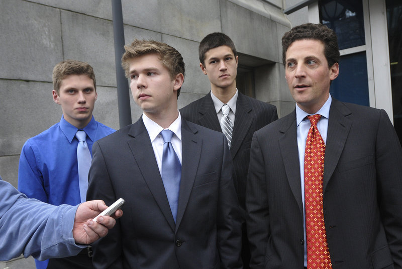 From left, Jackson Stevens, A.J. Asbury, Anthony Verville and attorney Paul Greene speak with the media after the three high school students lost their bid to play hockey on a Deering-Portland High co-op team.
