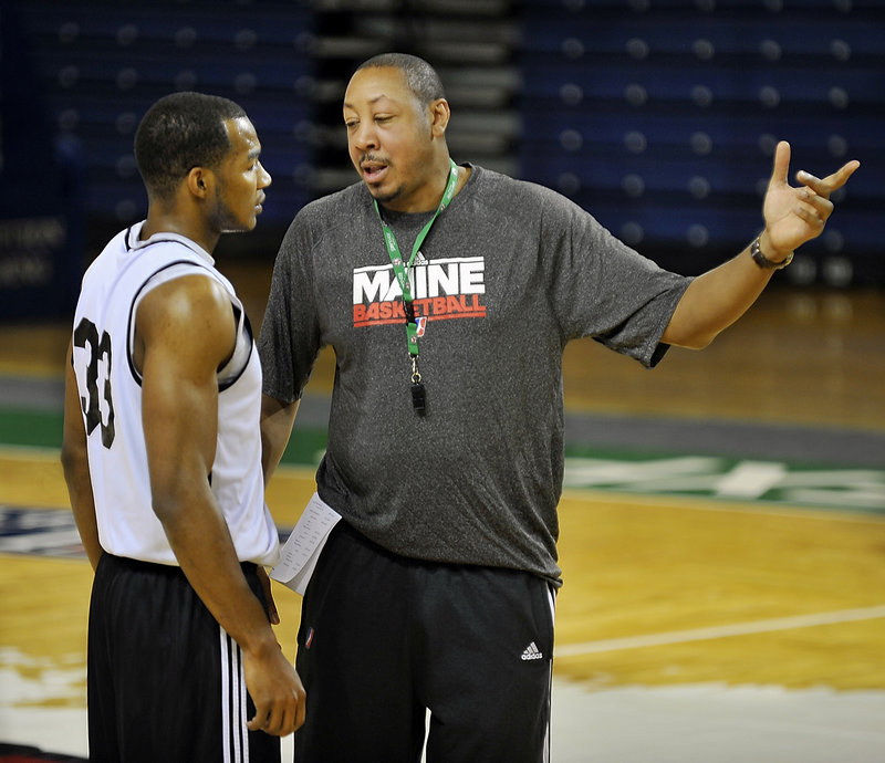 Chris Wright, left, who was the Red Claws’ first pick in the draft, chats with assistant coach Donyell Marshall during a recent practice. Wright and teammate Kenny Hayes are best friends and cousins.