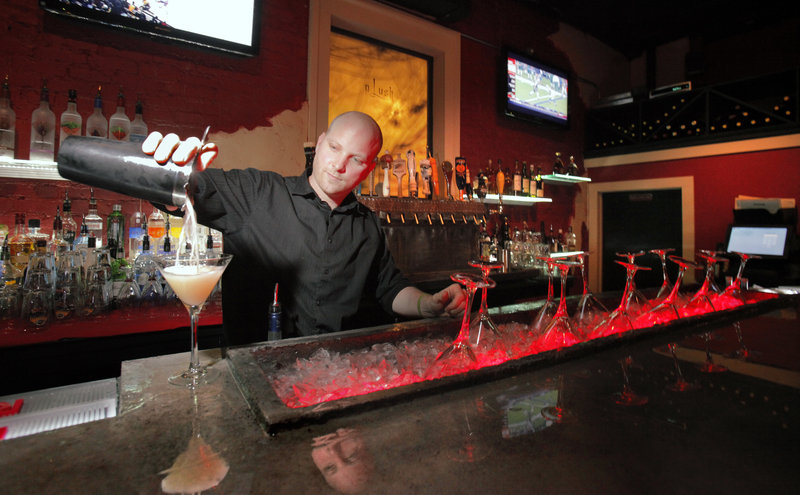 Bar manager Sean Steinmark, above, pours a Rangtang Cosmo at Plush West End in Portland, which comfortably fills the space occupied for years by Katahdin restaurant.