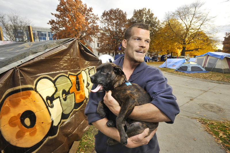 "From my understanding, there (won't) be any movement against Occupy Maine in Lincoln Park unless there's a health or safety issue," Chris Schisler said. His dog, Boss, is the unofficial camp mascot.