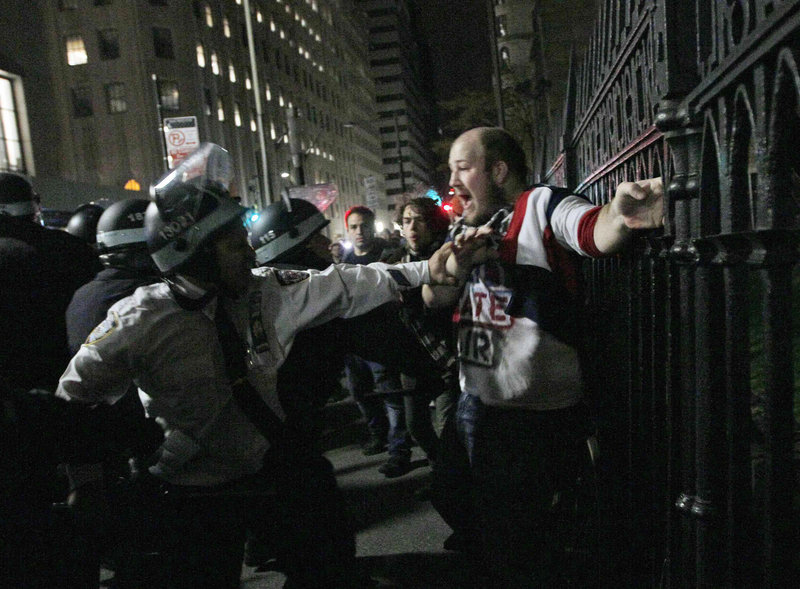 Protester Brent Schmidt of Brooklyn, N.Y., is arrested near the Occupy Wall Street encampment at Zuccotti Park in New York early Tuesday. Police handed out notices saying the park had to be cleared because it was unsanitary and hazardous.